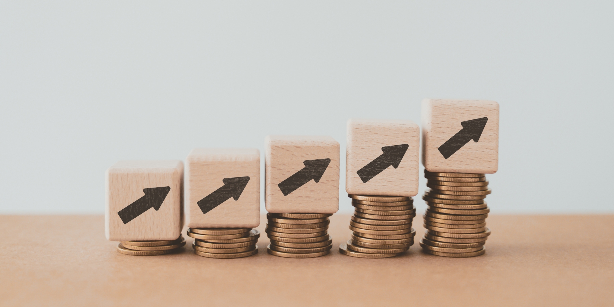 Fees increasing shown via stacks of coins increasing in number.