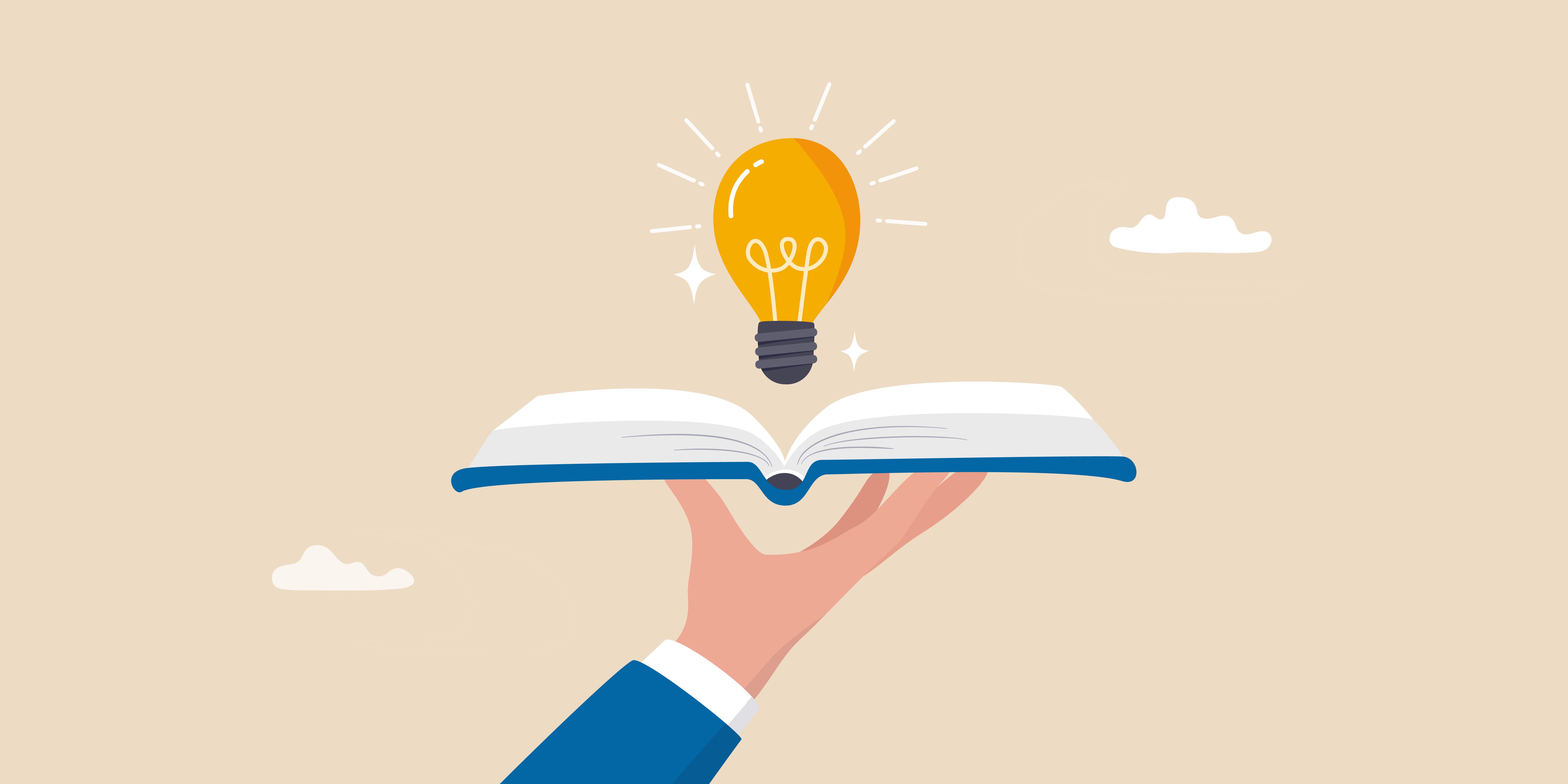 A hand holding a book with a lightbulb above it